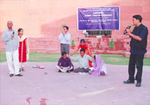 A National Street Theatre Workshop in progress  during  the MPs&rsquo; exposure visit, at the Jawahar Kala Kendra, Jaipur, Nov. 2005.   Seen are Mr. Chandrashekhar Reddy, MP from Andhra Pradesh suggesting alternative solution to the fusion imagery presented by young men depicting &lsquo;girl child discrimination.&rsquo;
