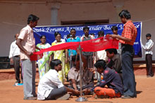 Young men performing street theatre at a Review Workshop projecting child marriage